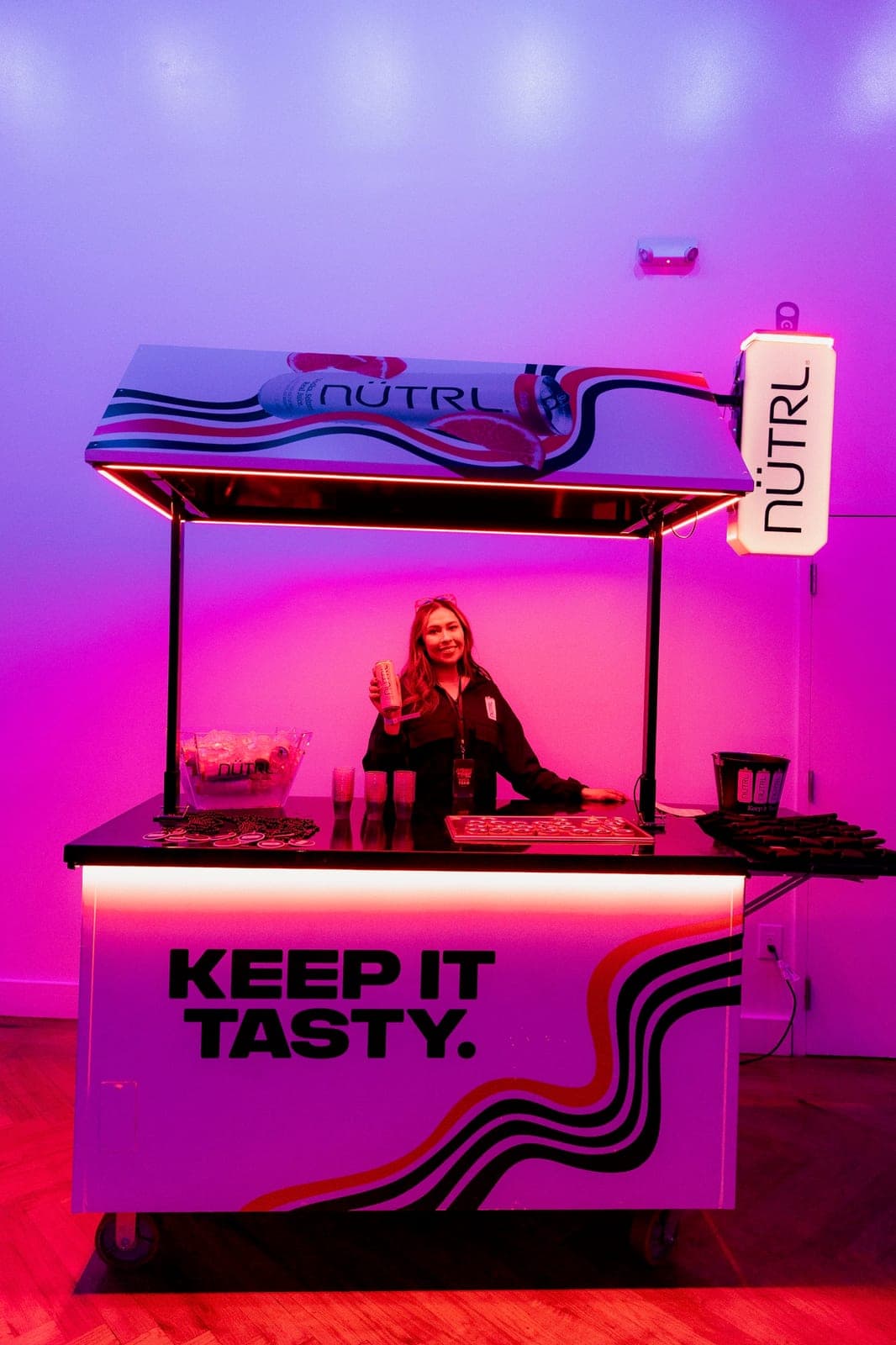 Branded NUTRL bar cart staffed at a campus event activation