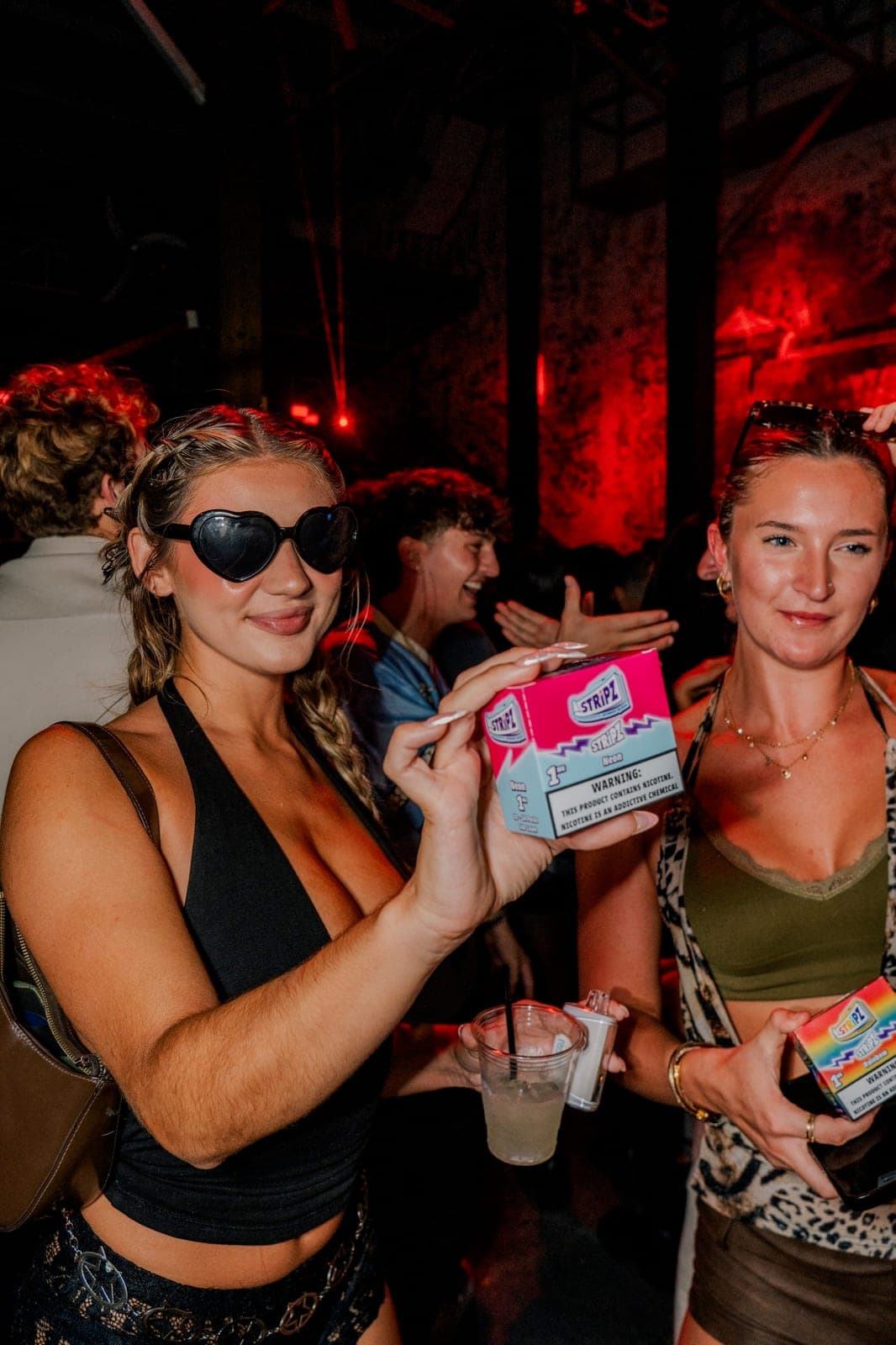 Two students with sponsor product at a campus nightlife activation